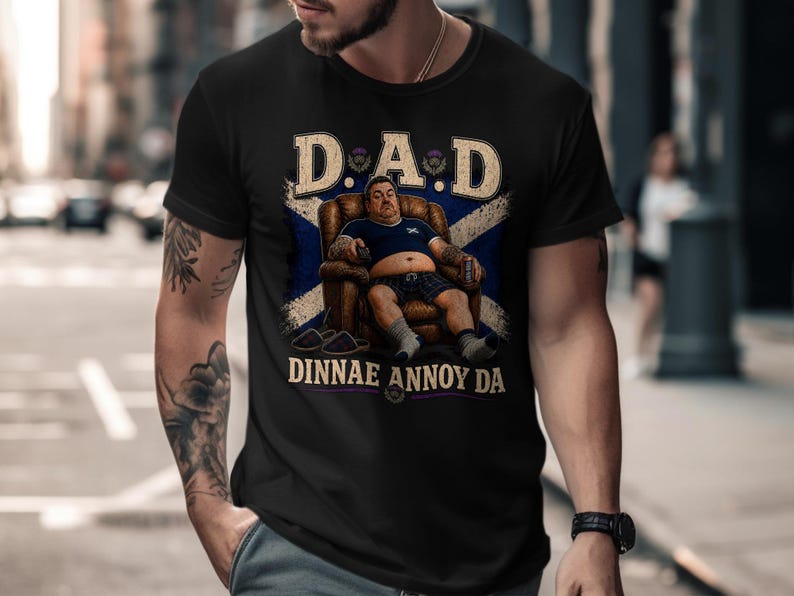 Black t-shirt with "DAD DINNAE ANNOY" text and tartan background.