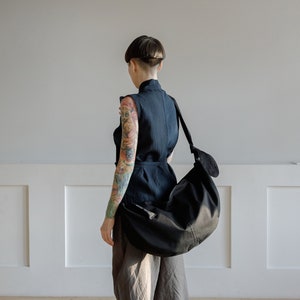 Hobo Bag: Spacious, semi-circular, black outer with green cotton lining, adjustable body strap, two inner pockets & lavender zip puller image 1