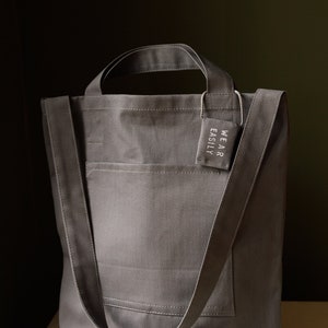 Grey cotton tote with dual pockets, top short handles, long body strap, and unique lavender sachet tag image 7