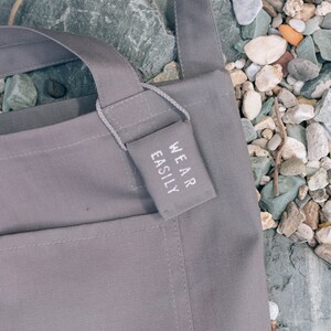 Grey cotton tote with dual pockets, top short handles, long body strap, and unique lavender sachet tag image 4