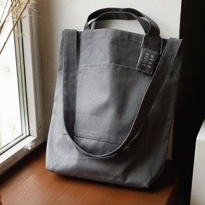 Grey cotton tote with dual pockets, top short handles, long body strap, and unique lavender sachet tag image 9