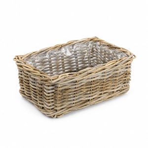 May include: A rectangular woven wicker basket featuring a natural light brown finish and a clear plastic liner fitted inside. The basket is constructed with a sturdy, open-weave design, showcasing the organic texture of the willow material.