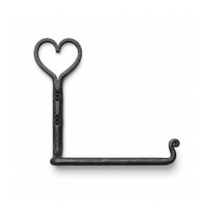 May include: Black metal toilet paper holder with a heart-shaped top. The holder has a vertical bar with two screws and a horizontal bar with a decorative curled end. The design is simple and elegant.