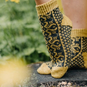May include: A pair of yellow and black patterned socks with a geometric design. The socks are made of a soft, comfortable material and are perfect for everyday wear.