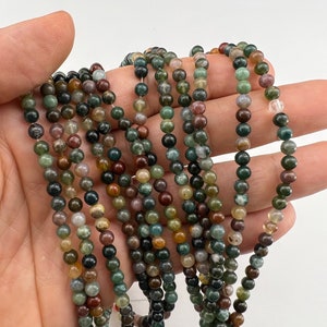 4mm Indian agate stone beads strand stacked and held in hand from a close look