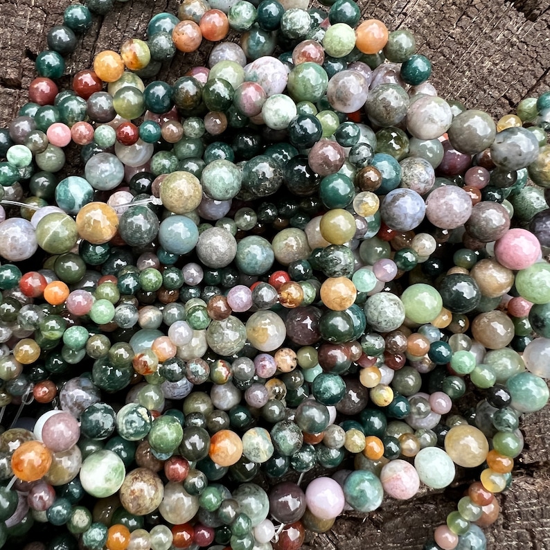 Indian agate stone beads strand stacked on a trunk from above
