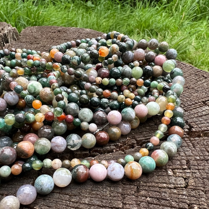 Indian agate stone beads strand stacked and twisted on a trunk