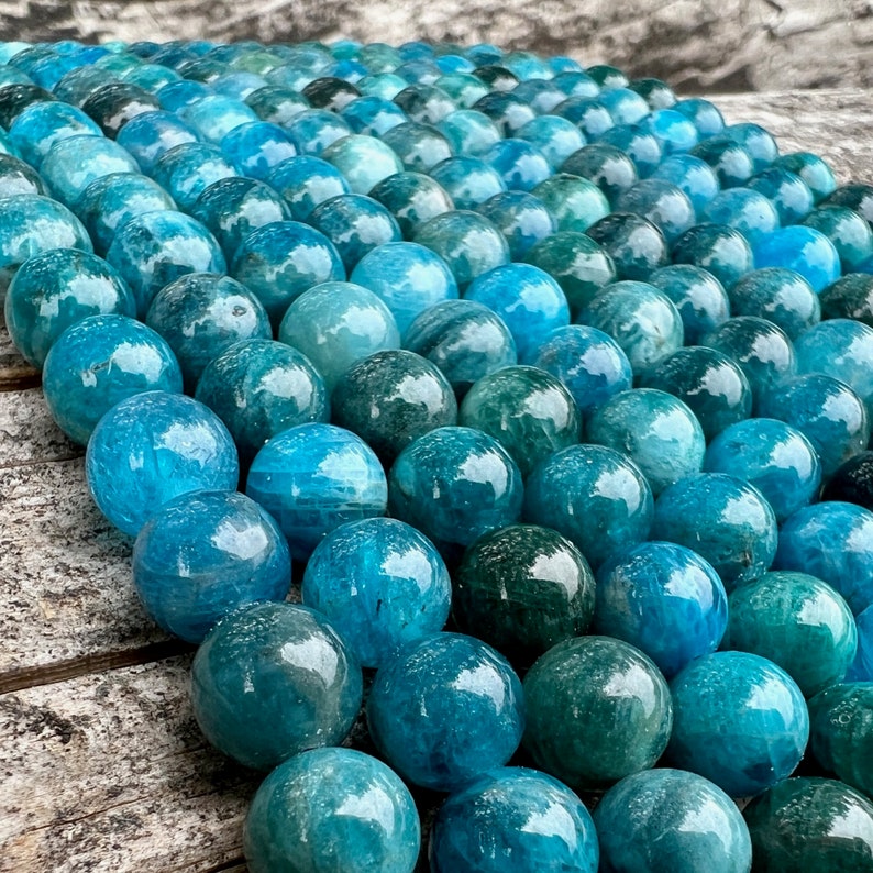 Apatite stone beads strands on top a trunk