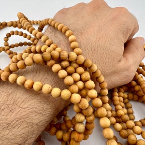 size 6mm wooden beads shown on wrist
