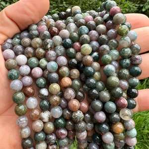 8mm Indian agate stone beads strands stacked and held in hand from a close look