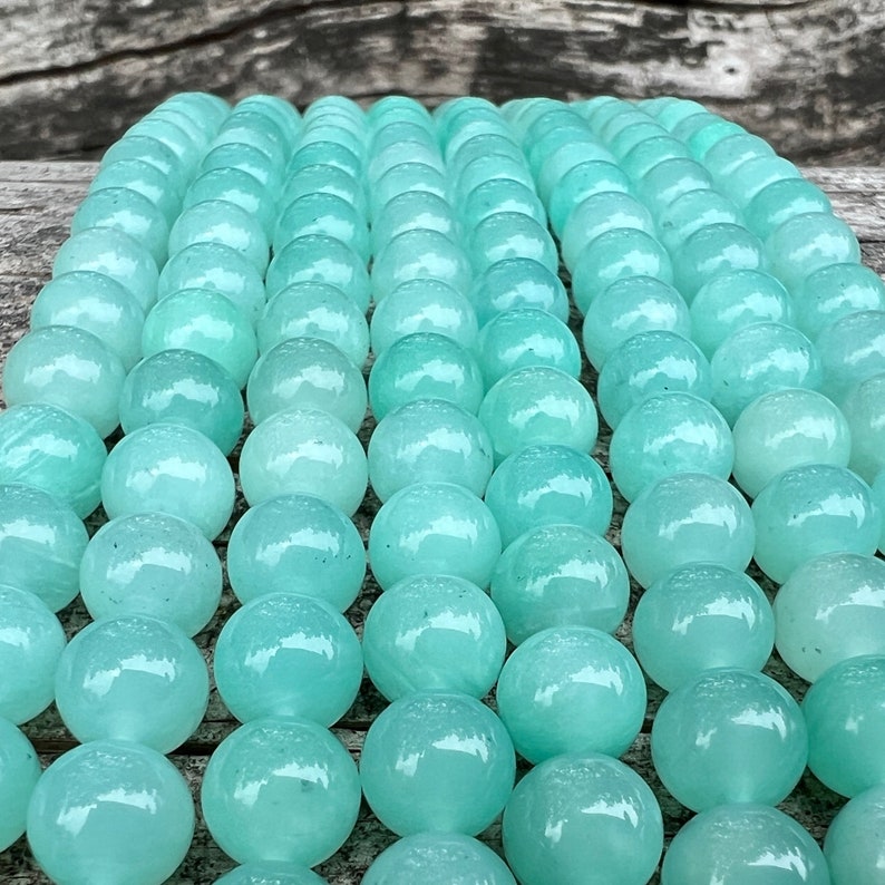amazonite beads strands stacked on a trunk from front view