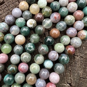 Indian agate stone beads strand stacked on a trunk from a close look