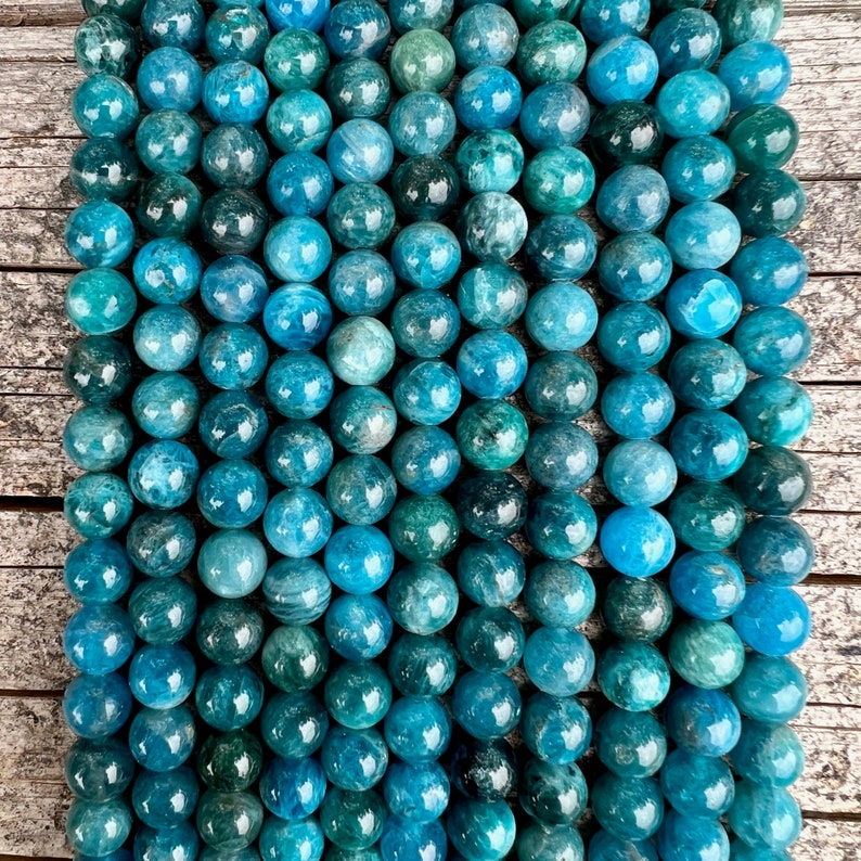 Apatite stone beads strands on top a trunk pictured from above