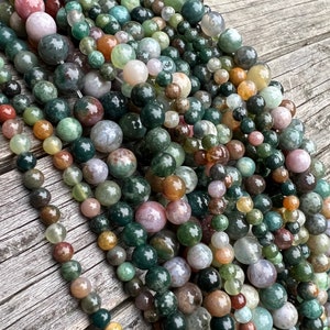 Indian agate stone beads strand stacked on a trunk