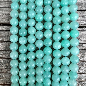 amazonite beads strands stacked on a trunk from above