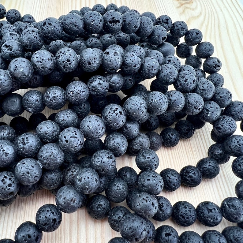 lava beads strand laid on a bright wood board