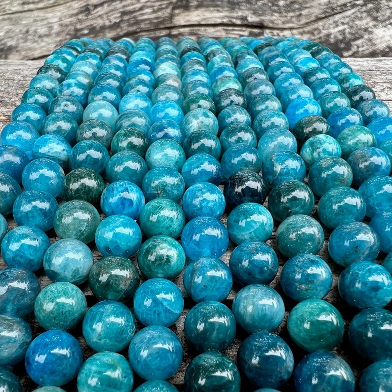 Apatite stone beads strands on top a trunk