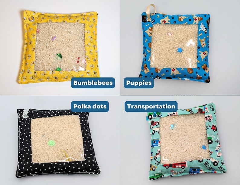May include: Four square sensory pouches with clear plastic windows filled with rice and small hidden objects. The fabric borders feature patterns of bumblebees, puppies, polka dots, and transportation vehicles, each with a small metal grommet.