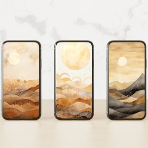 May include: Three smartphones displaying landscape watercolour art. Each phone shows a different scene: a full moon over rolling hills, a large sun over layered arches, and a moon over mountain peaks. The colour palette is warm, with shades of brown, gold, and beige.