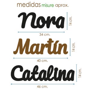 May include: Three wooden name signs: Nora (34 cm wide, 14 cm tall), Mart&iacute;n (40 cm wide, 14 cm tall), and Catalina (46 cm wide, 14 cm tall). The Nora and Catalina signs are black, while Mart&iacute;n is brown.