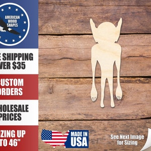 May include: A wooden cutout of a tall, thin alien figure with long arms and legs. The cutout is on a brown wooden background. The image also includes text that says "Made in USA" and "See Next Image for Sizing".