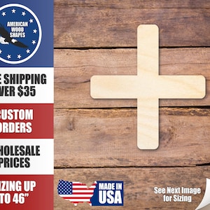 May include: A plain, unfinished wooden cross shape, made in the USA. The cross is on a brown wood background.