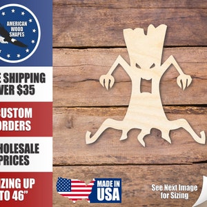 May include: A wooden cutout of a scary tree with a face and arms. The tree is on a woodgrain background. The cutout is made in the USA.