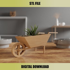 May include: A wooden wheelbarrow planter with a succulent plant. The planter is light brown and has a wheel and two handles. The text "STL FILE" and "DIGITAL DOWNLOAD" are displayed in the image.