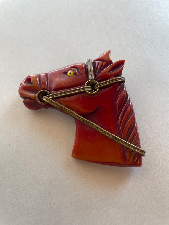 Vintage orange/red Bakelite and brass horse pin