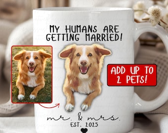 May include: White ceramic mug with a photo of two dogs and the text "My humans are getting married! Add up to 2 pets! mr. & mrs. Est. 2025"