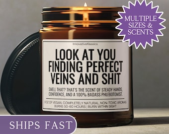 May include: A brown glass jar candle with a black lid, featuring a label with the text "LOOK AT YOU FINDING PERFECT VEINS AND SHIT." The candle has a lit wick and a purple sticker that says "MULTIPLE SIZES & SCENTS."