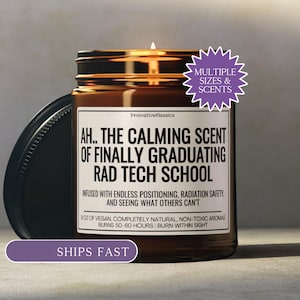 May include: A brown glass jar candle with a black lid. The label reads "AH.. THE CALMING SCENT OF FINALLY GRADUATING RAD TECH SCHOOL." The candle is infused with vegan, natural, non-toxic aromas and burns for 50-60 hours. A purple sticker says "MULTIPLE SIZES & SCENTS."