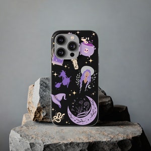 May include: A black phone case with a purple and white witchy design. The design features a witch on a broomstick, a cauldron, a crescent moon, and stars.