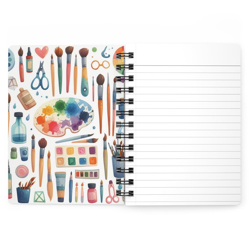 Puede incluir: Un cuaderno de espiral con una cubierta blanca que presenta un patr&oacute;n colorido de pinceles, paletas de pintura y otros materiales de arte.