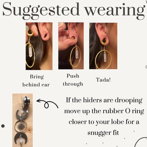 May include: A close-up of a gold hoop earring with a clear crystal pendant. The earring is shown being worn in a stretched earlobe. The image shows how to wear the earring, with instructions to bring the earring behind the ear and then push it through the earlobe.