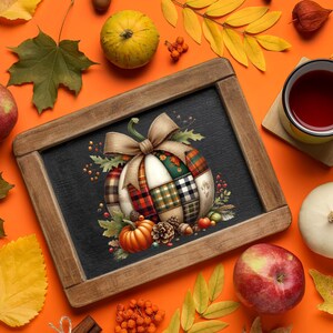 May include: A chalkboard with a pumpkin design, surrounded by fall foliage, apples, and a cup of tea. The pumpkin is decorated with a patchwork pattern in red, green, and white. The background is orange.