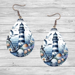 May include: A pair of teardrop-shaped earrings with a nautical theme. The earrings feature a lighthouse with black and white stripes, an anchor, seashells, and seagulls against a blue ocean background.