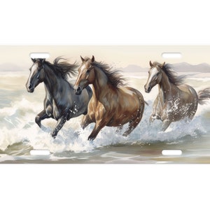 May include: Three horses run through the ocean waves. The horses are brown, gray, and white. The water is splashing around them as they gallop.