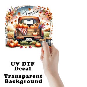 May include: A colorful fall-themed UV DTF decal featuring a vintage red truck filled with pumpkins. The image includes the text "Happy Fall" and is surrounded by floral and leaf accents. The decal has a transparent background.
