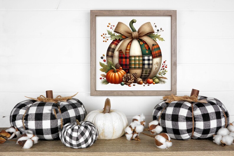 May include: A framed watercolor print of a patchwork pumpkin with a large bow, surrounded by fall foliage.  Three fabric pumpkins in black and white buffalo check, a white pumpkin, and cotton sprigs are arranged on a wooden surface, creating a seasonal display.