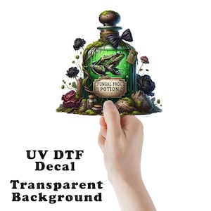 May include: A green glass bottle with a cork stopper and a black ribbon. The bottle contains a green liquid and a green frog. The bottle is surrounded by black and red flowers and moss. The label on the bottle reads "Fungal Frog Potion".