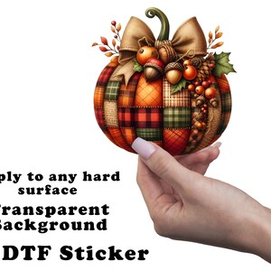 May include: A colorful patchwork pumpkin with a brown bow and acorns. The pumpkin is on a white background with the text "Apply to any hard surface Transparent Background UV DTF Sticker".