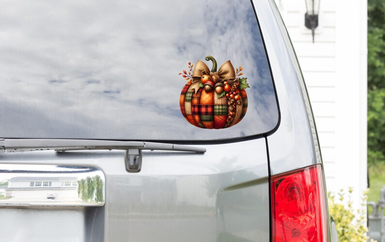 May include: A plaid pumpkin with a brown bow and fall-themed decorations. The pumpkin is on a white car with a window.