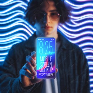 May include: A smartphone mockup held in front of a blurred background of blue neon lights. The phone screen displays the time 8:25, the words "MOBILE SCREEN MOCKUP", and the resolution 2532*1170 px.