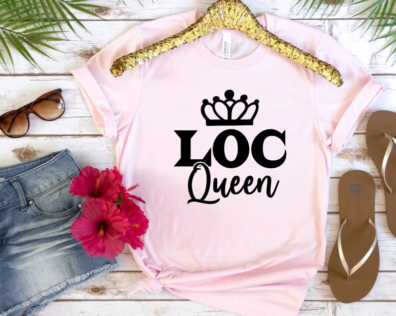 May include: Pink t-shirt with a black crown and the text "LOC Queen" printed on the front.
