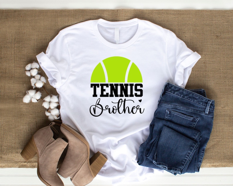May include: White t-shirt with a green tennis ball graphic and the text "Tennis Brother" in black.