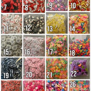 May include: A collection of 26 small bags filled with colorful, themed, and decorative sprinkles. The sprinkles are arranged in a grid pattern and numbered 7 through 26. The sprinkles include hearts, stars, flowers, lemons, and other shapes.