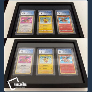 May include: Six Pokemon trading cards are displayed in a black frame with a black mat. The cards are graded 8.5, 9, and 9.5. The cards are protected by museum glass. The frame has a label that reads "PRESENTEC FRAME WHAT YOU LOVE" and "STANDARD ECHTGLAS".