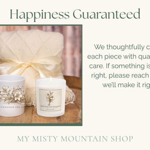 May include: A cream-colored blanket tied with a satin ribbon, a white mug with floral design and text "Consider the Lilies", and a lit candle with a label. The image includes the text "Happiness Guaranteed".