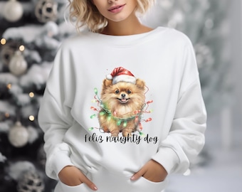 May include: White sweatshirt with a festive illustration of a Pomeranian dog wearing a Santa hat and tangled in Christmas lights. The text "Feliz naughty dog" is printed below the image.